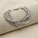 Bracciale Multifili Spiga con cuscino chiaro su lino beige