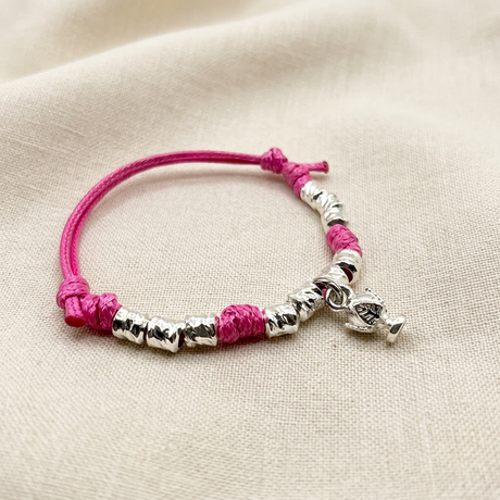 Cordino e Pumino Fucsia su lino beige